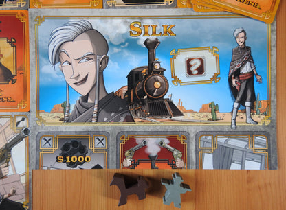 Close-up view of the brilliantly-designed character sheet and wooden pieces included in the Colt Express Silk Bandit mini expansion.