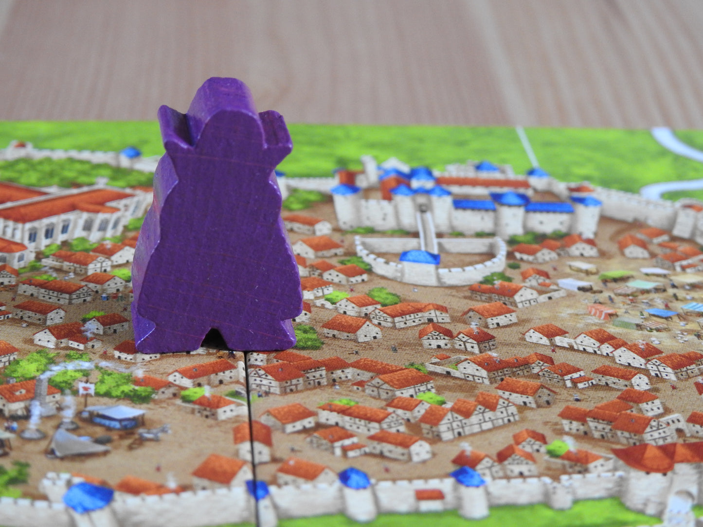 Close-up of the Count meeple figure stalking the streets of Carcassonne. Residents: beware!