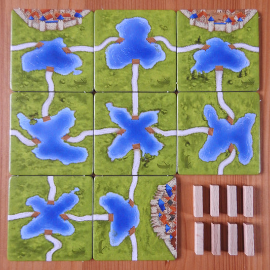 View of all the tiles and ferry pieces included in this Carcassonne Ferries mini expansion.