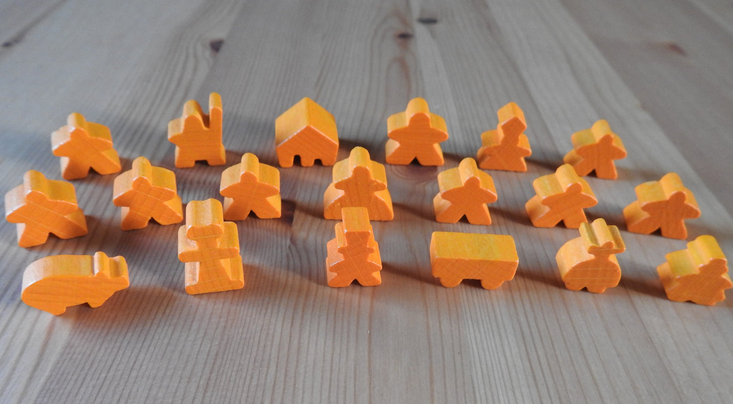 Close-up view of the orange wooden meeple set.