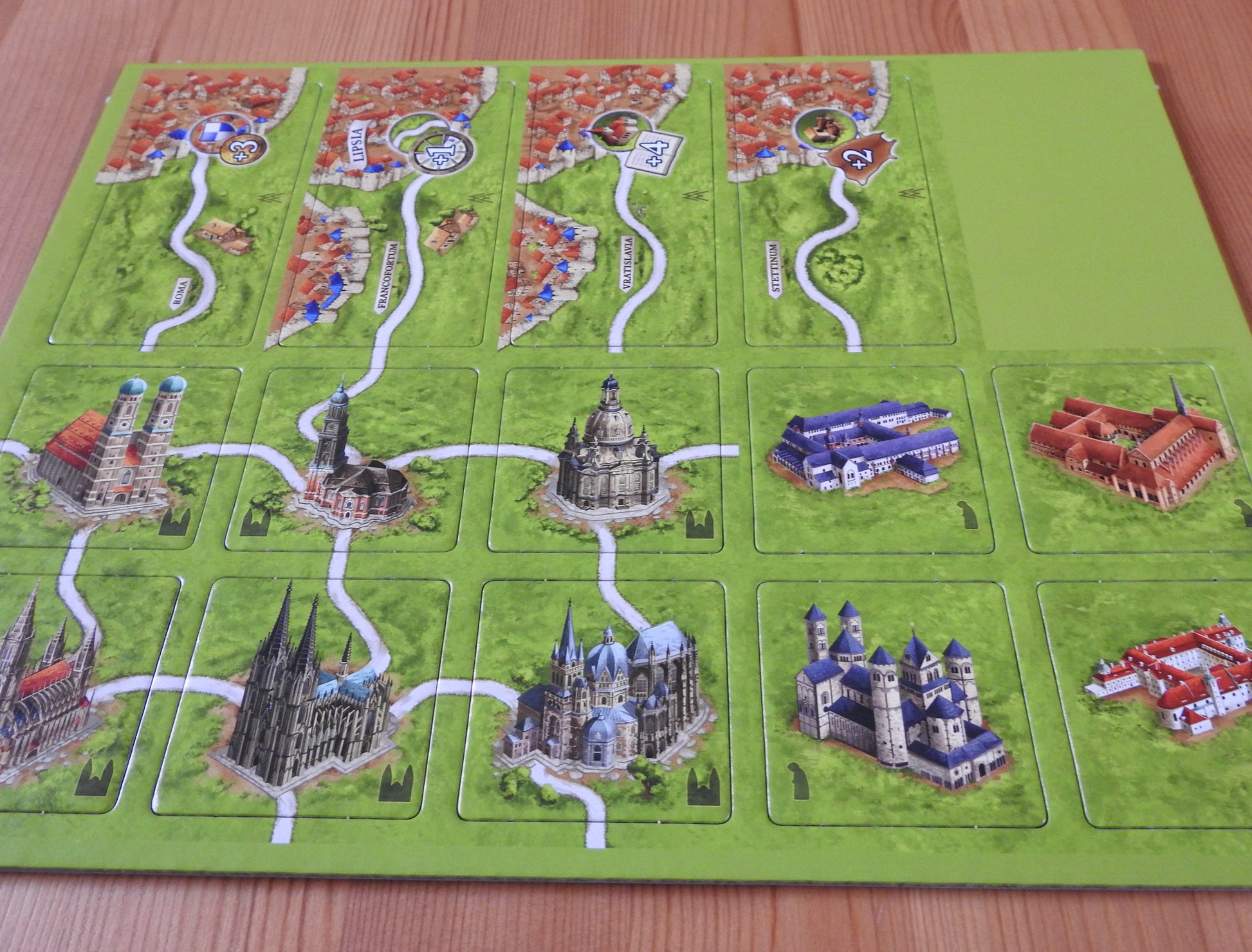 Closer view of the sheet that includes the Markets of Leipzig and German Cathedrals tiles, as well as 4 German Monasteries tiles in this 4 Mini Expansion Bundle for the Carcassonne board game.