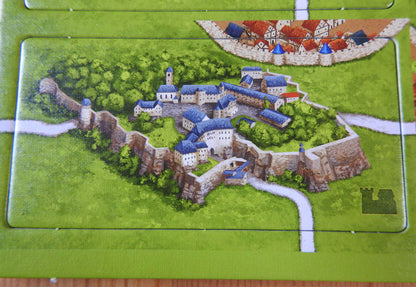 A close-up view of a different castle with blue roofed buildings in this German Castles mini expansion for Carcassonne.