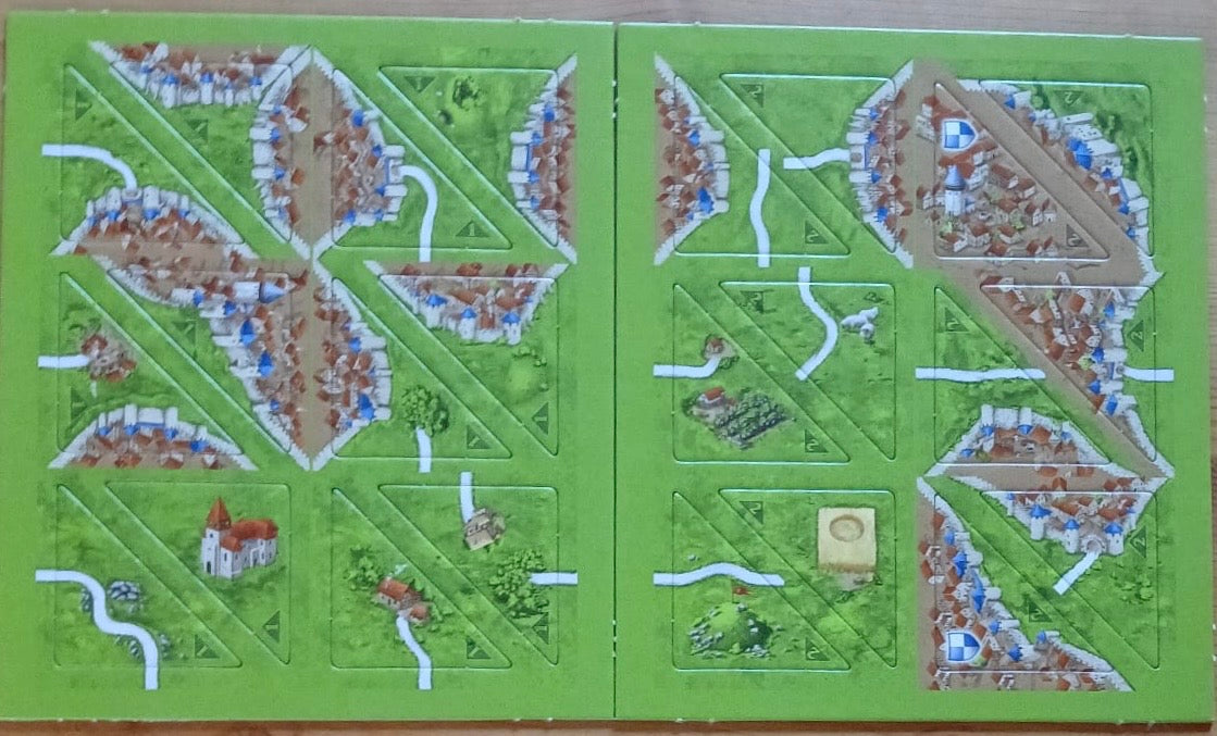 View of all 24 of the half-sized tiles that make up this Halflings 1 & 2 mini expansion for the Carcassonne board game.