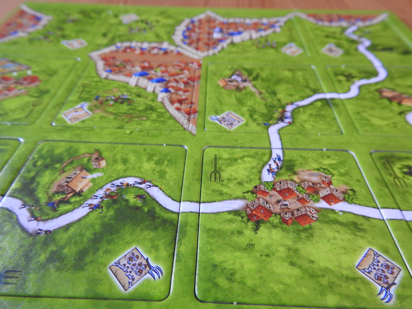Close-up view of some of the included titles, including the local citizenry uprising in this Peasant Revolts mini expansion for Carcassonne.
