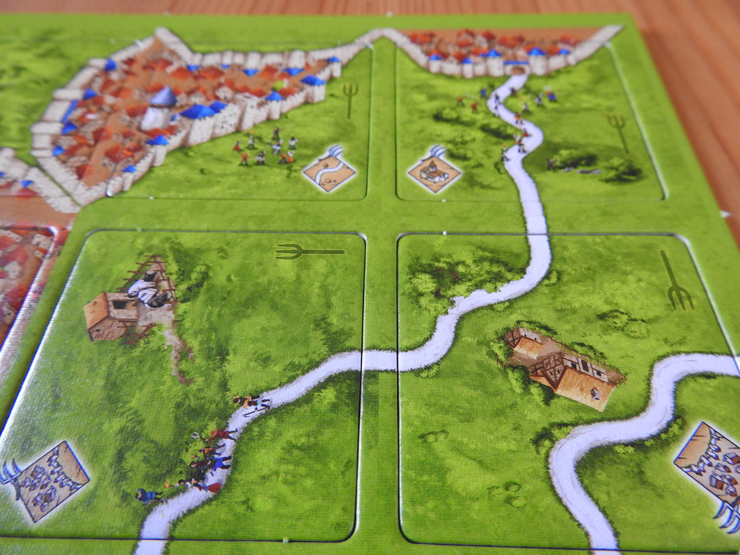 A further view of some of the included tiles, with village buildings and cities connected by roads in this Peasant Revolts mini expansion for Carcassonne.