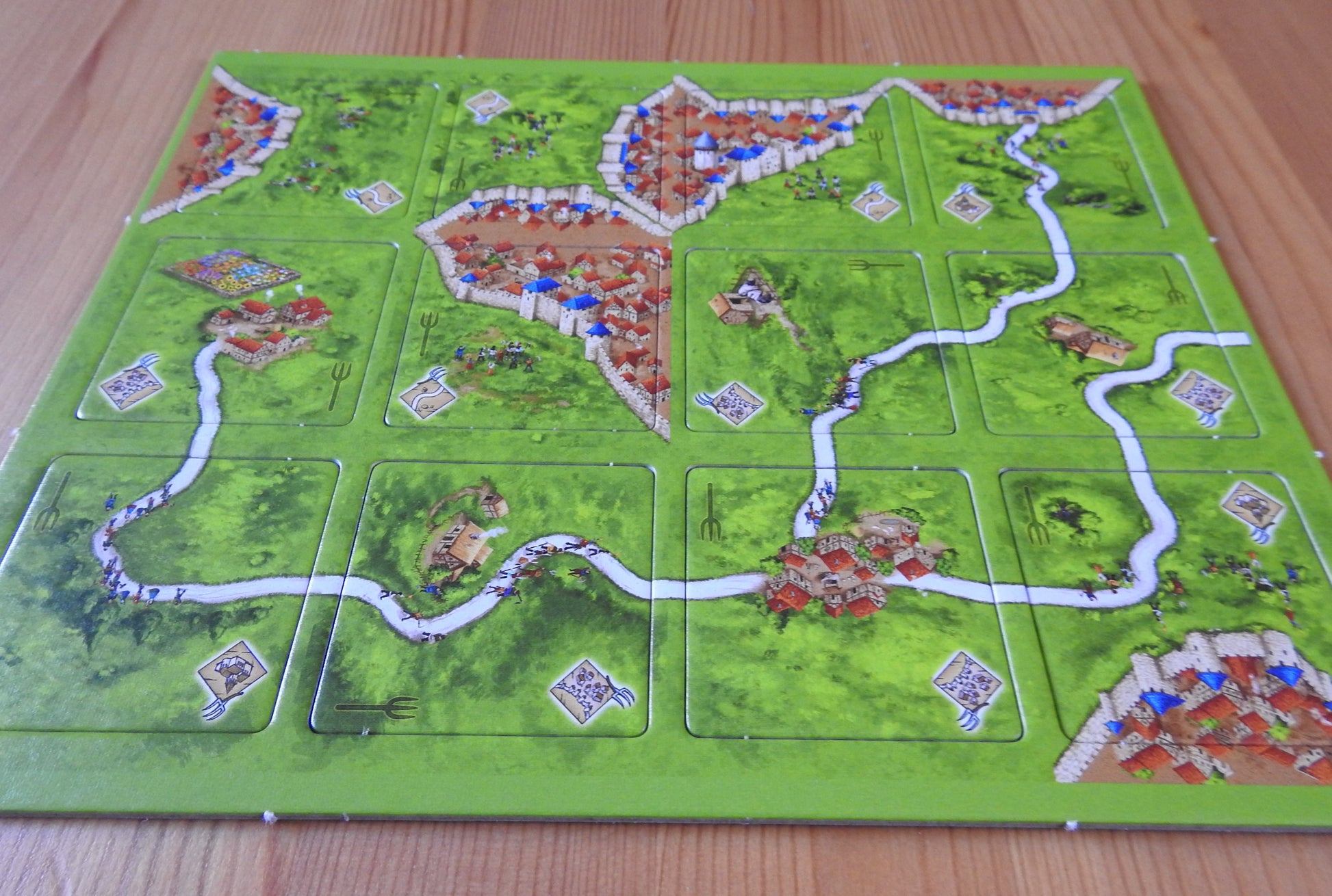 A view from a lower angle of all 12 included tiles in this Peasant Revolts mini expansion for Carcassonne.