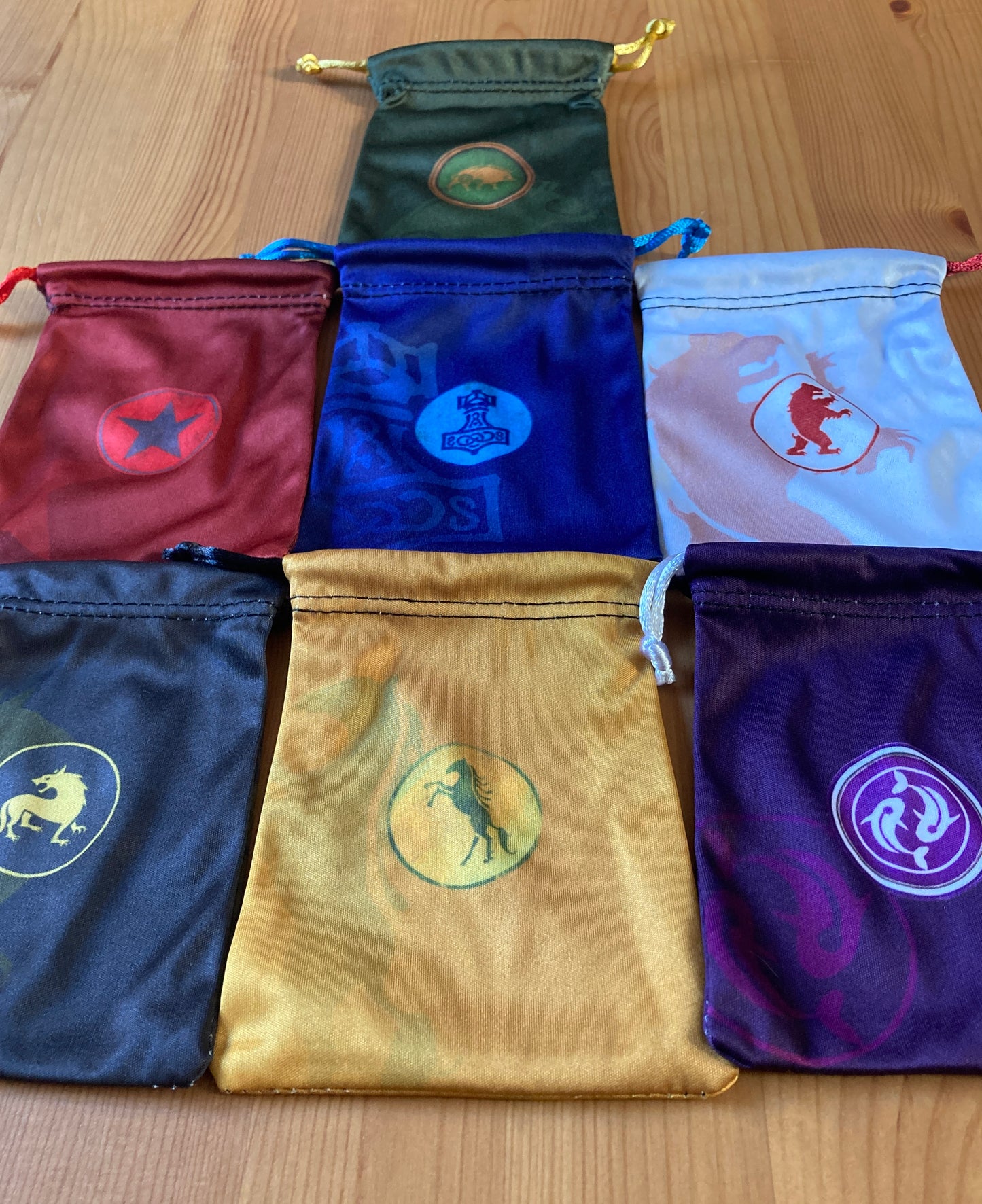 Closer view of all 7 of the faction bags included in this accessory for Scythe.