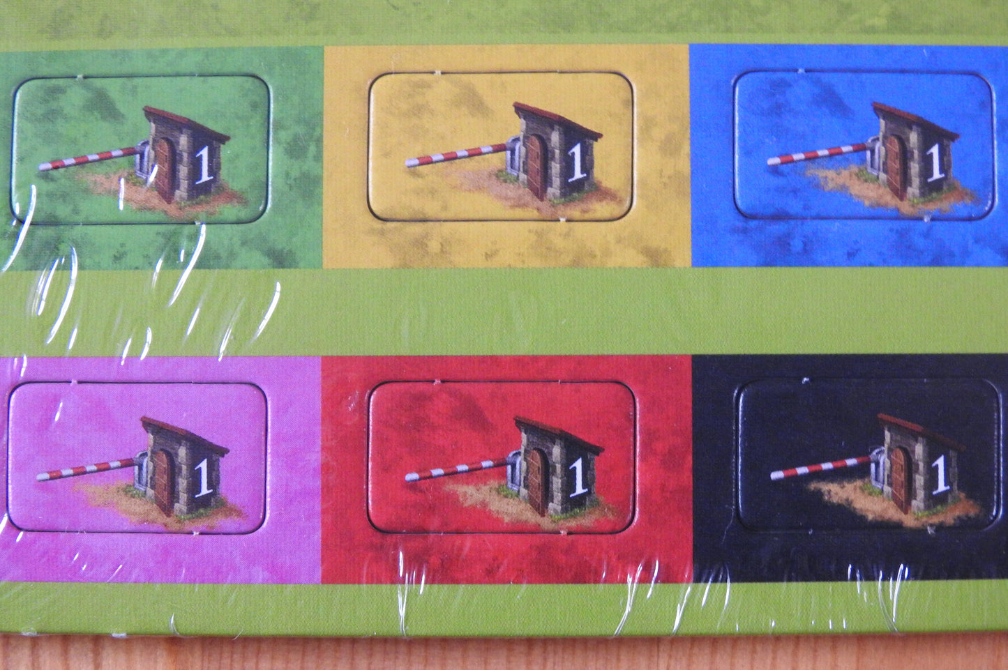 Close-up of the 6 tollkeeper tokens shown in their different colours.