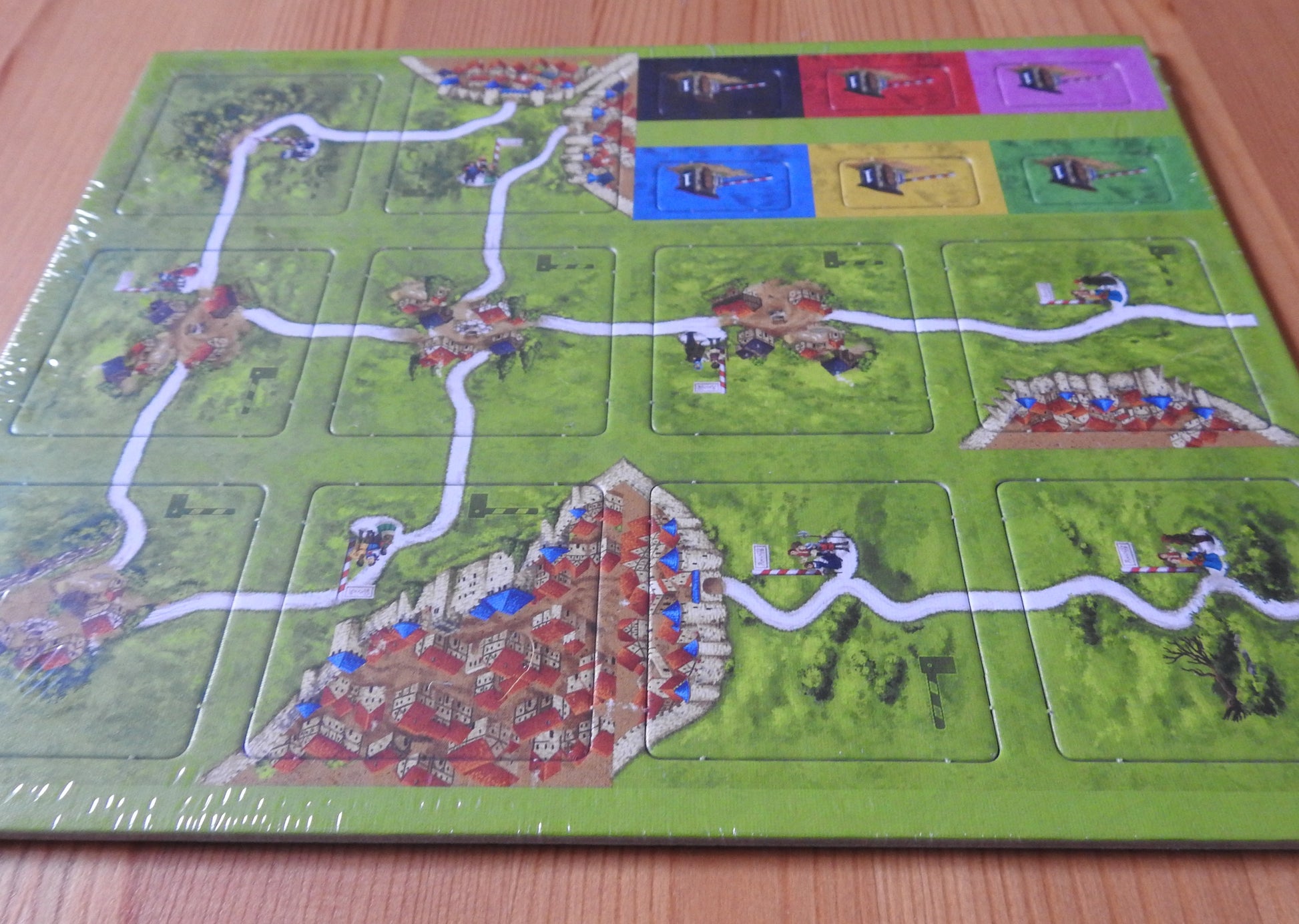 Lower angle view of the 10 tiles and 6 toll tokens that come with this Tollkeepers Carcassonne Mini Expansion.