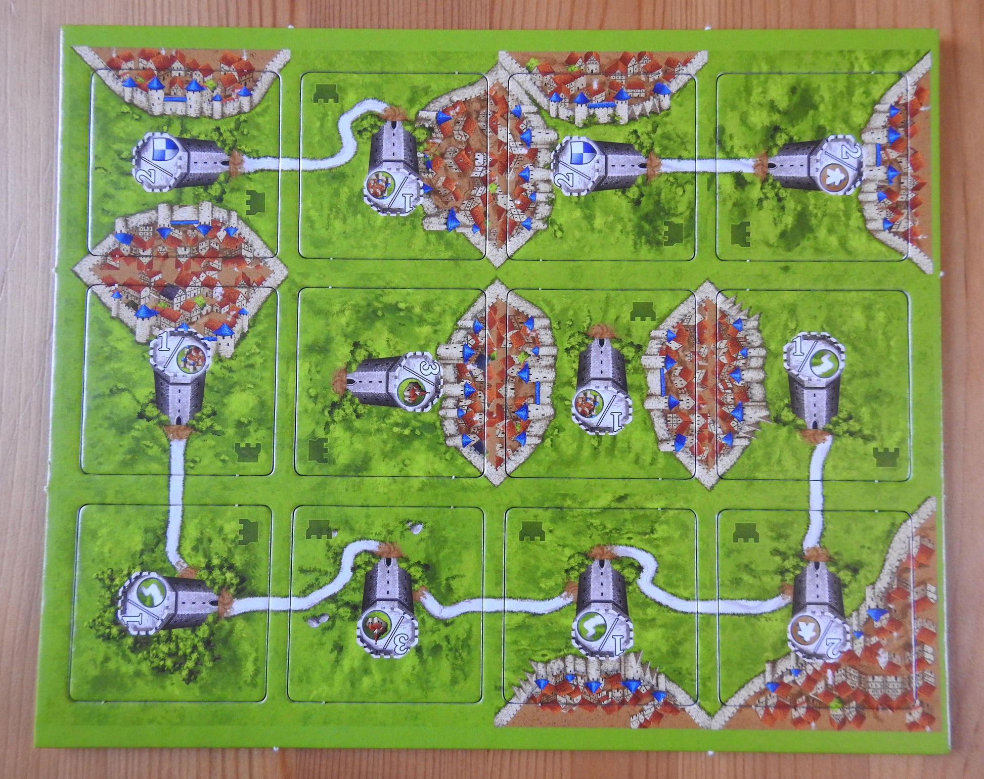 View from above showing all of the 12 landscape tiles featured in this Watchtowers mini expansion for the Carcassonne board game.