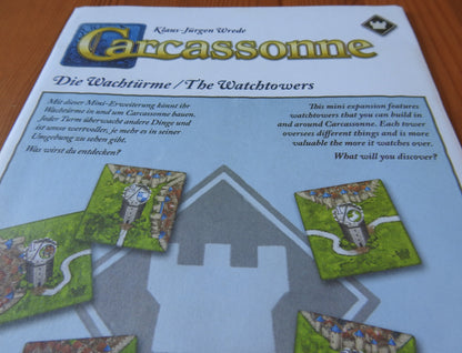 View of the envelope with descriptive text that this Watchtowers mini expansion for the Carcassonne board game comes in.