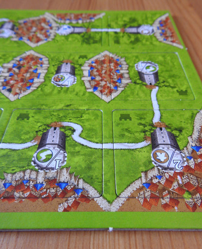 Close-up view of more of the included landscape tiles, featuring cities, roads and watchtowers in this Watchtowers mini expansion for the Carcassonne board game.