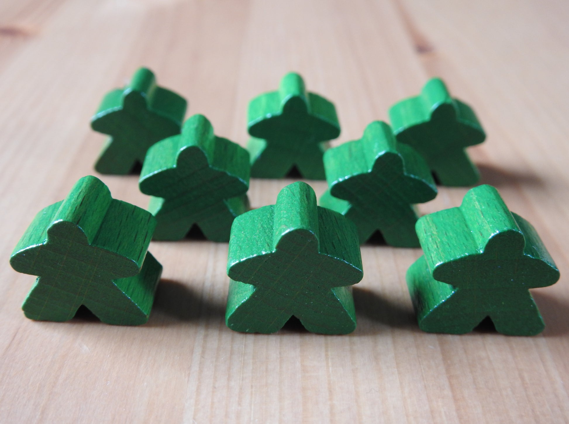 Close-up view of the dark green set of 8 meeples.