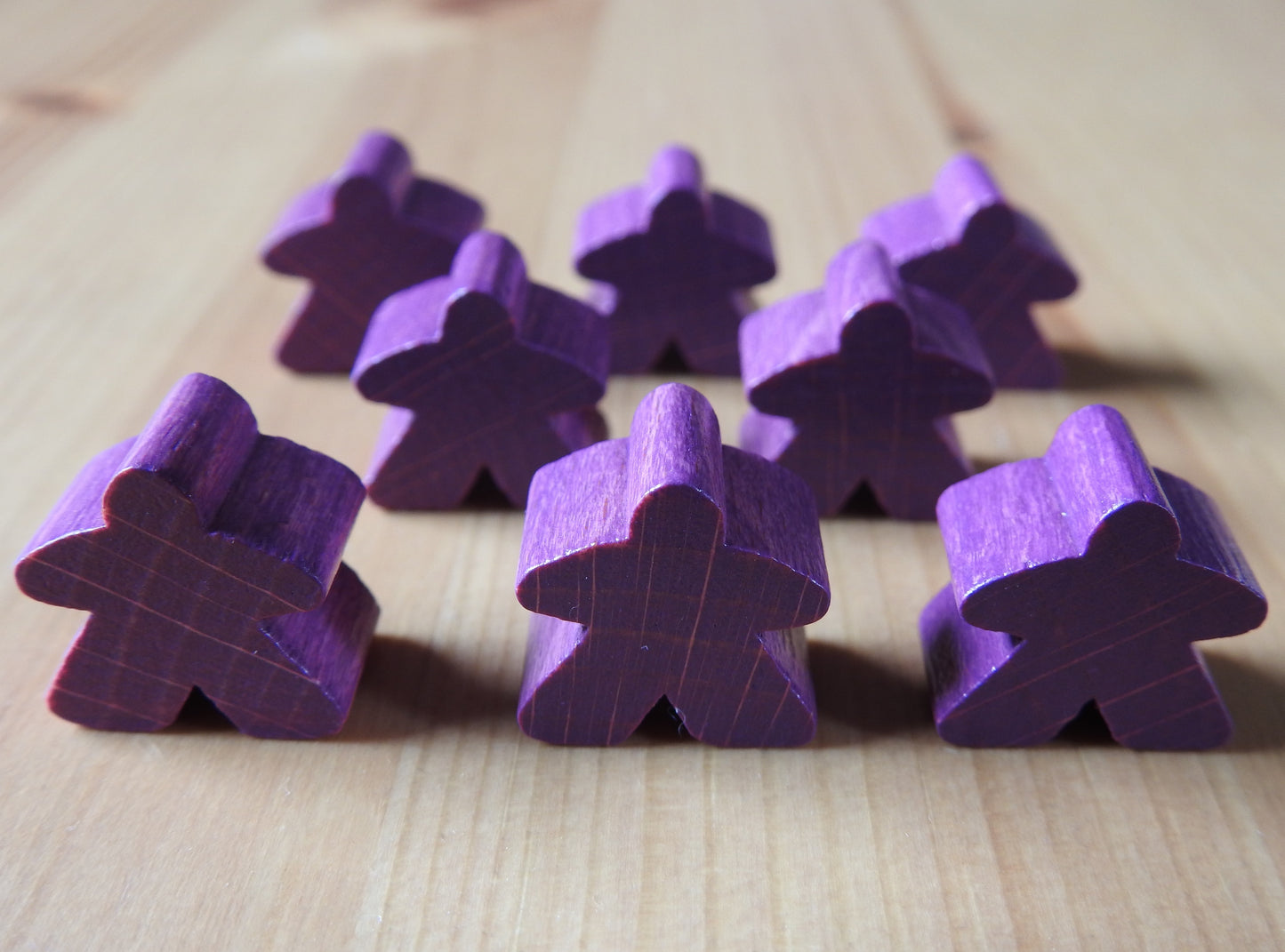 Close-up view of the purple set of 8 meeples.
