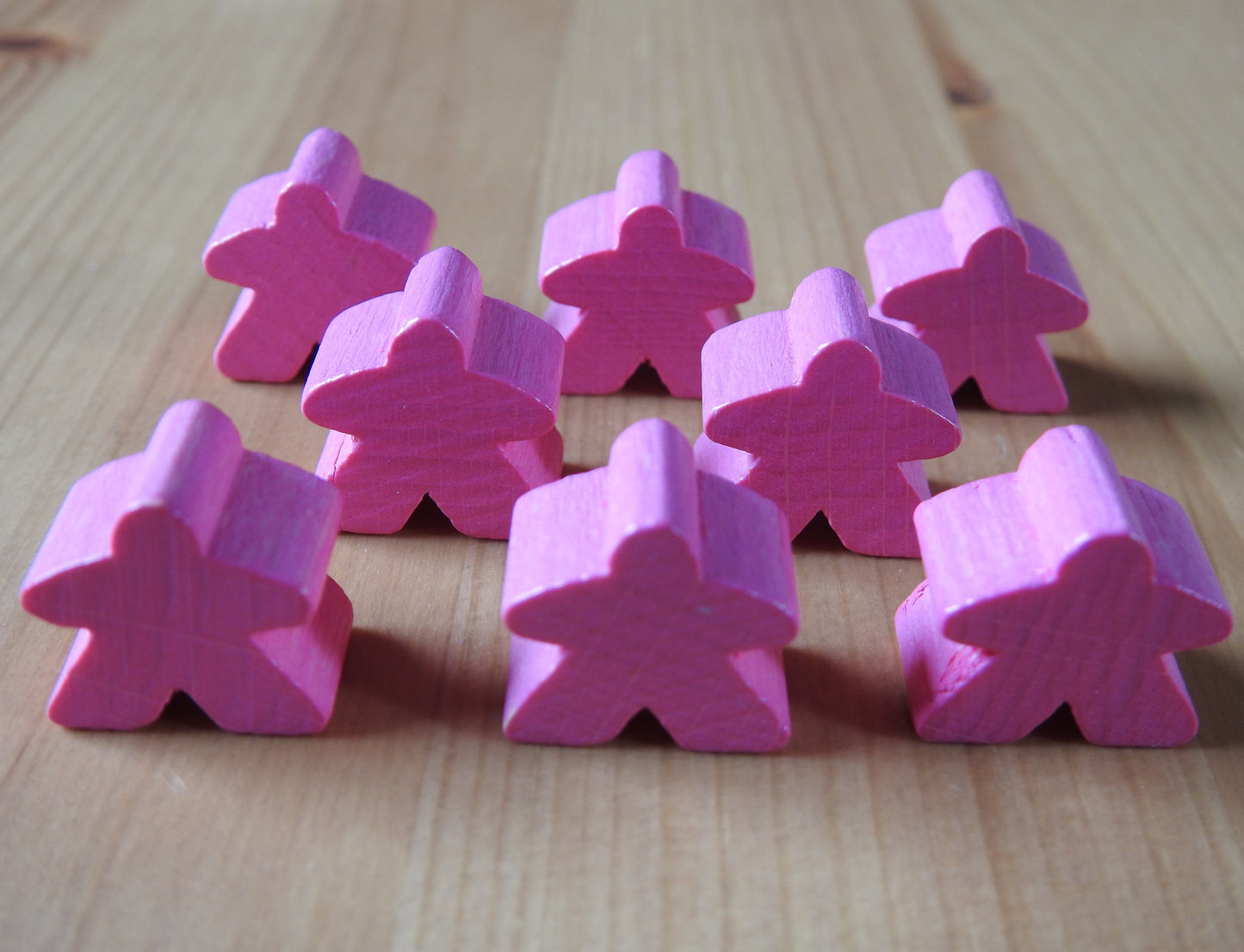 Close-up view of the pink set of 8 meeples.