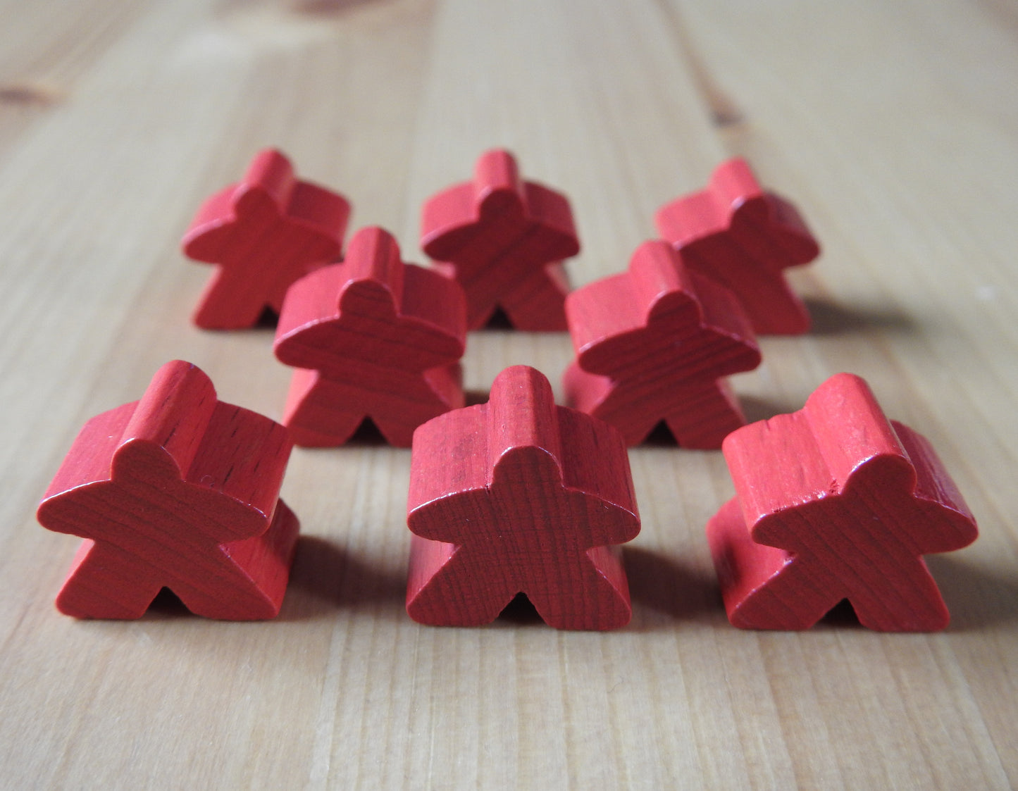 Close-up view of the red set of 8 meeples.