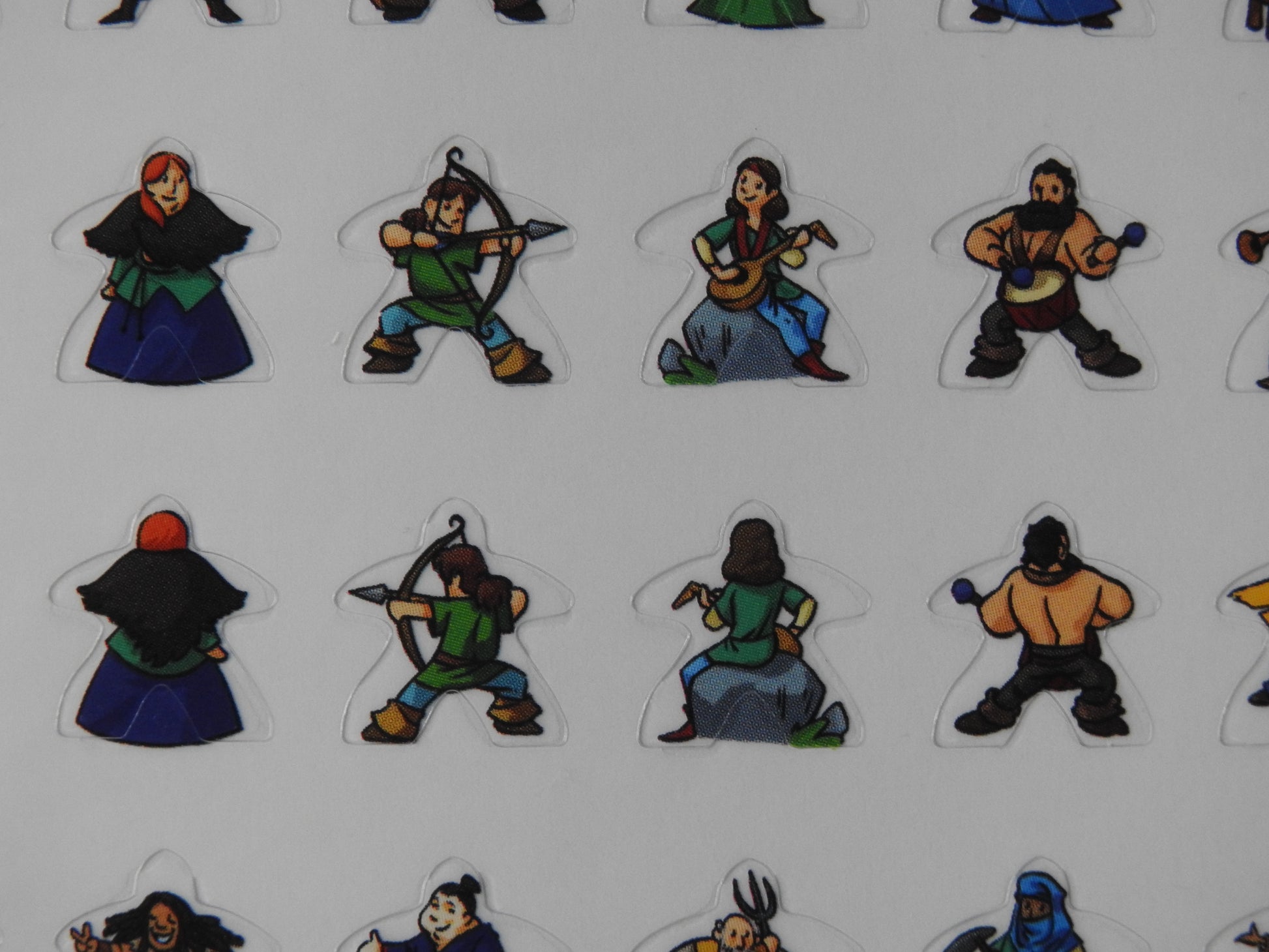 Close-up view of some of the meeple stickers, including an archer, a musician and a drummer.
