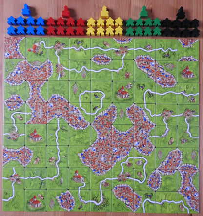 View of all 72 landscape tiles and the meeples and abbots that come with this Carcassonne Unboxed Base Game.