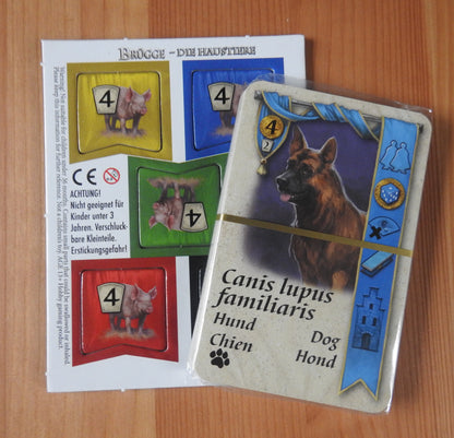 View of the deck of cards in its shrink wrapping and the unpunched tokens.
