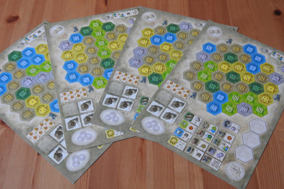 View showing all four of the game boards that are included with this Castles of Burgundy Monastery Boards Expansion.