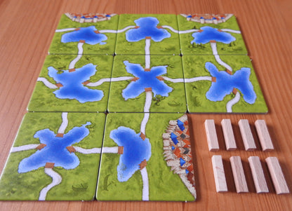 A final view of all the tiles and wooden pieces next to each other in this Carcassonne Ferries expansion.