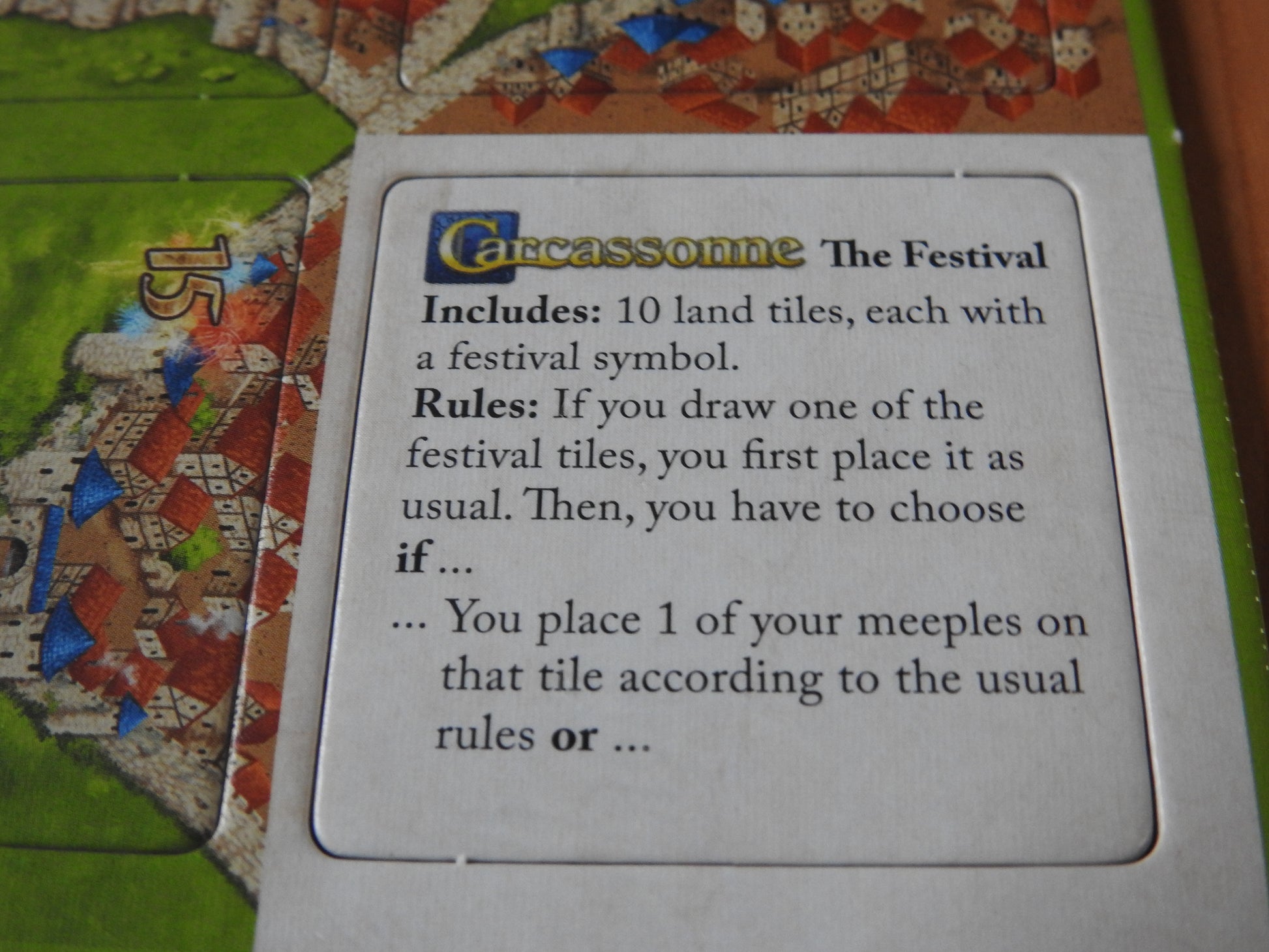 Close-up of the English rules tile in this Carcassonne Festival II mini expansion.