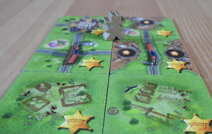 Close-up of the six Gold Rush tiles, along with the Sheriff meeple figure looking tough!