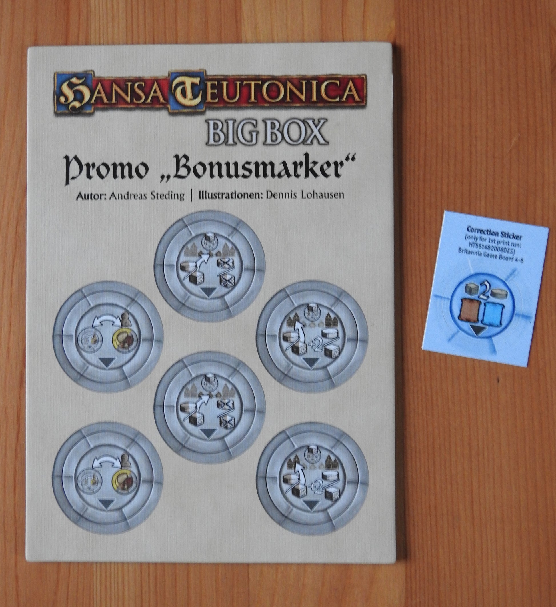 View of the 6 new bonus markers, along with the correction sticker, that are included in this mini expansion for Hansa Teutonica.