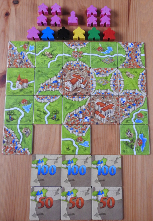 View of all the tiles and meeples that come with this Carcassonne Inns & Cathedrals expansion.