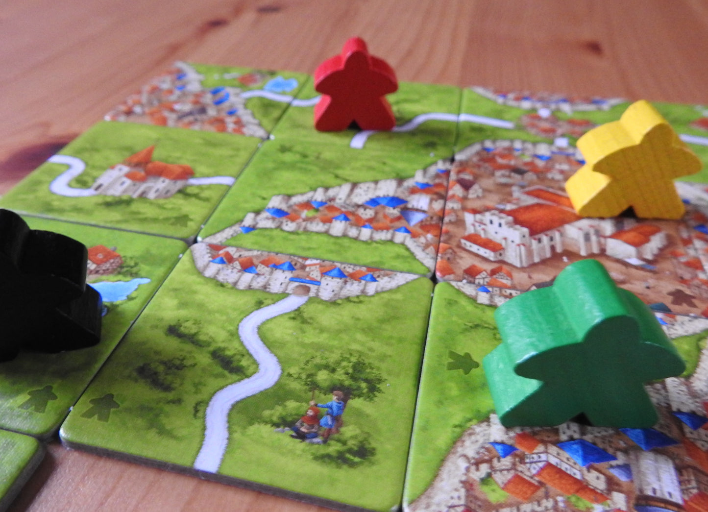 Some more meeples, tiles and abbots included in this Carcassonne Inns & Cathedrals expansion.