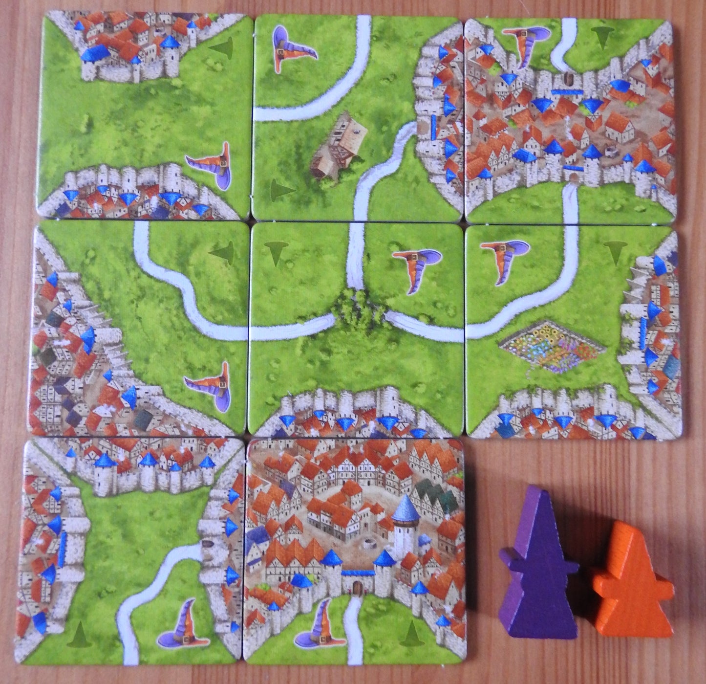 View of the landscape tiles and special meeple figures included in this Carcassonne Mage & Witch expansion.
