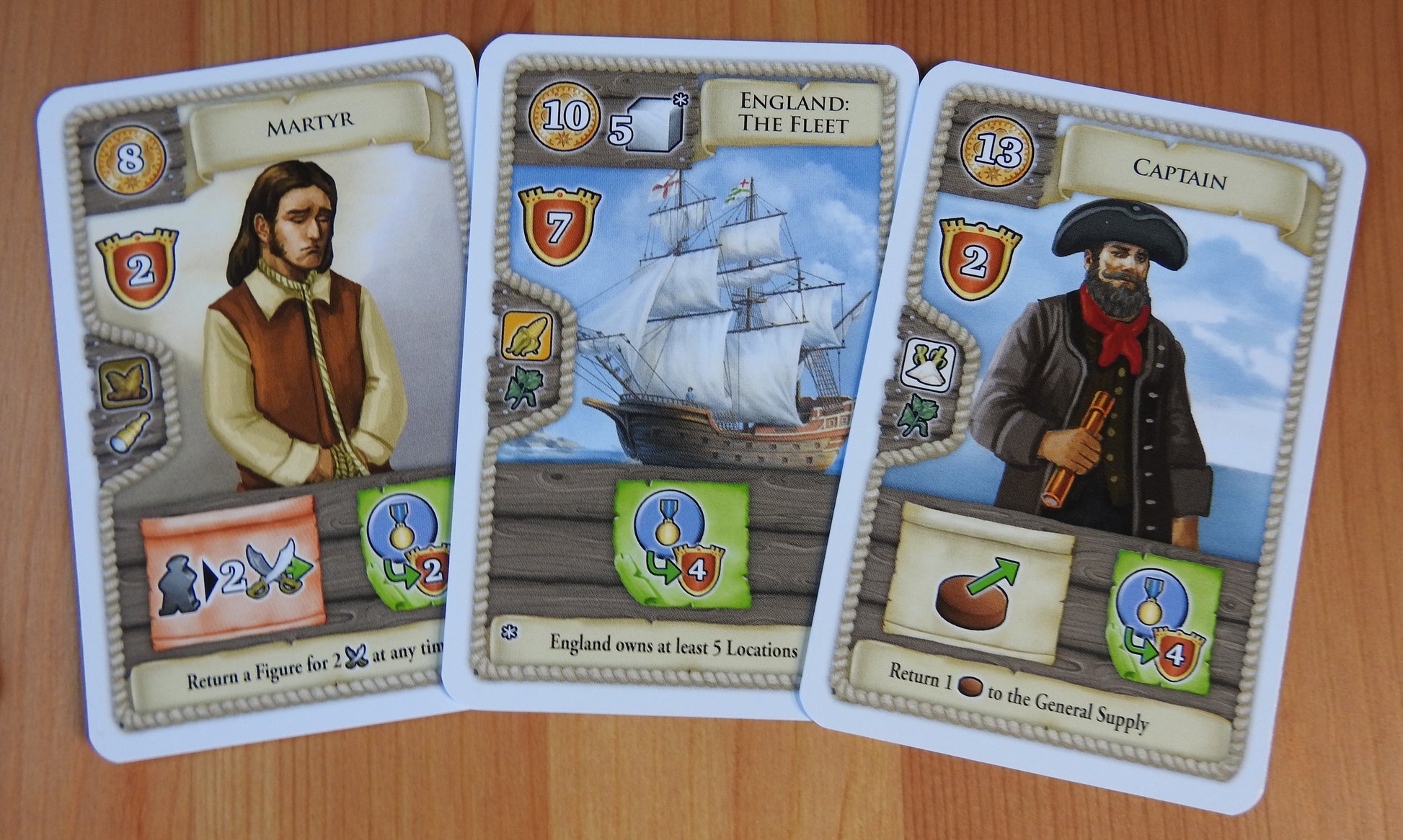 Close-up view of three cards - Martyr, England: The Fleet and the Captain.