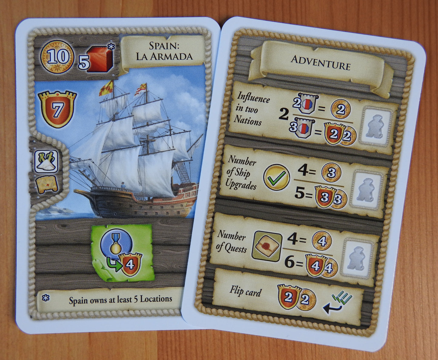 Close-up view of 2 cards: Spain: La Armada and the Adventure card.
