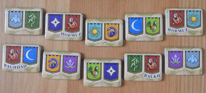 Close-up view of the 10 goal tokens included, featuring all the different city shields.