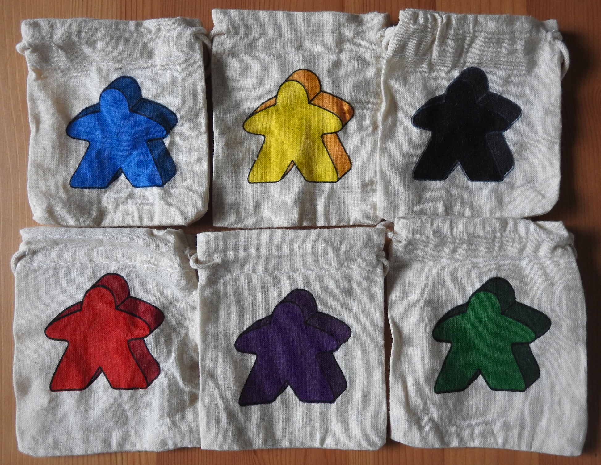 View of all 6 of the meeple bags that are included.