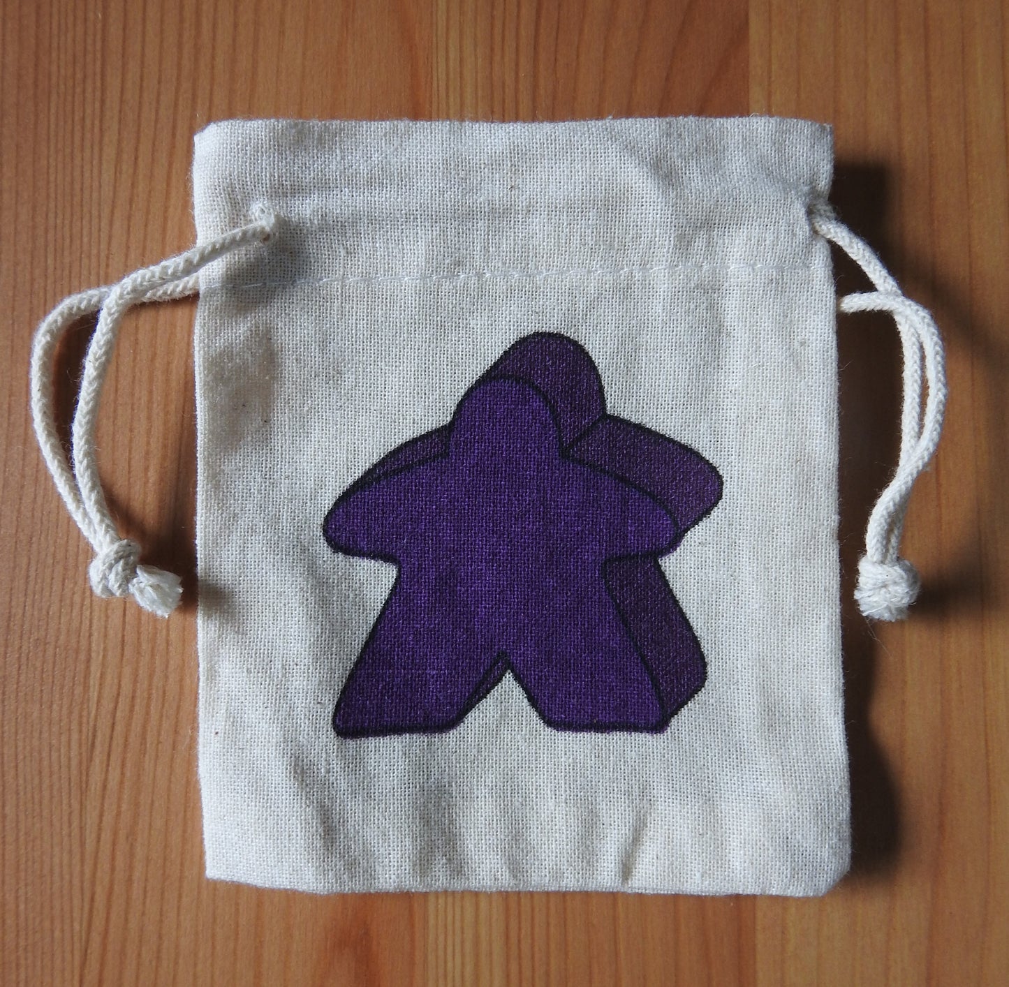 Close-up of the purple meeple bag.
