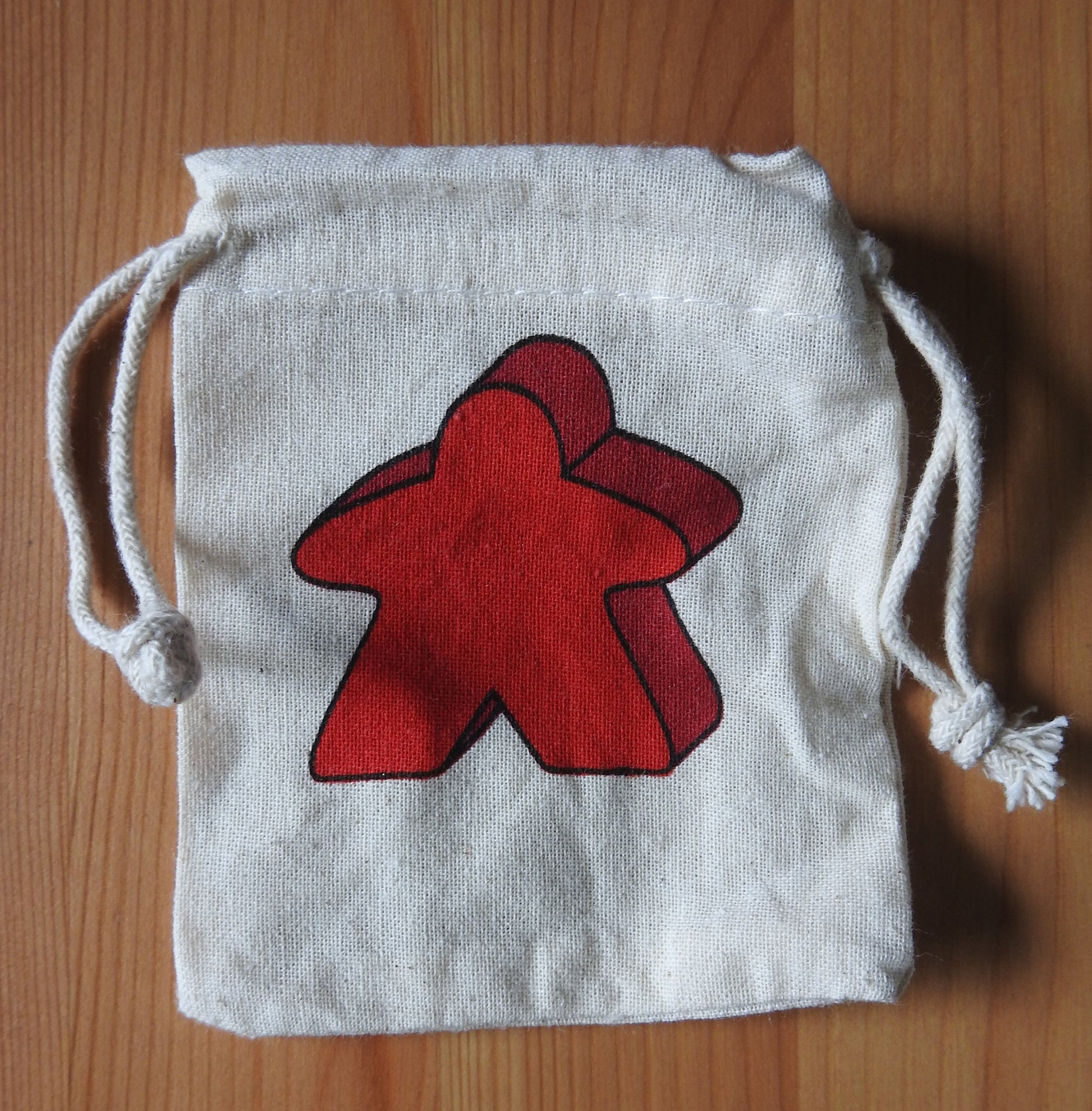 Close-up of the red meeple bag.