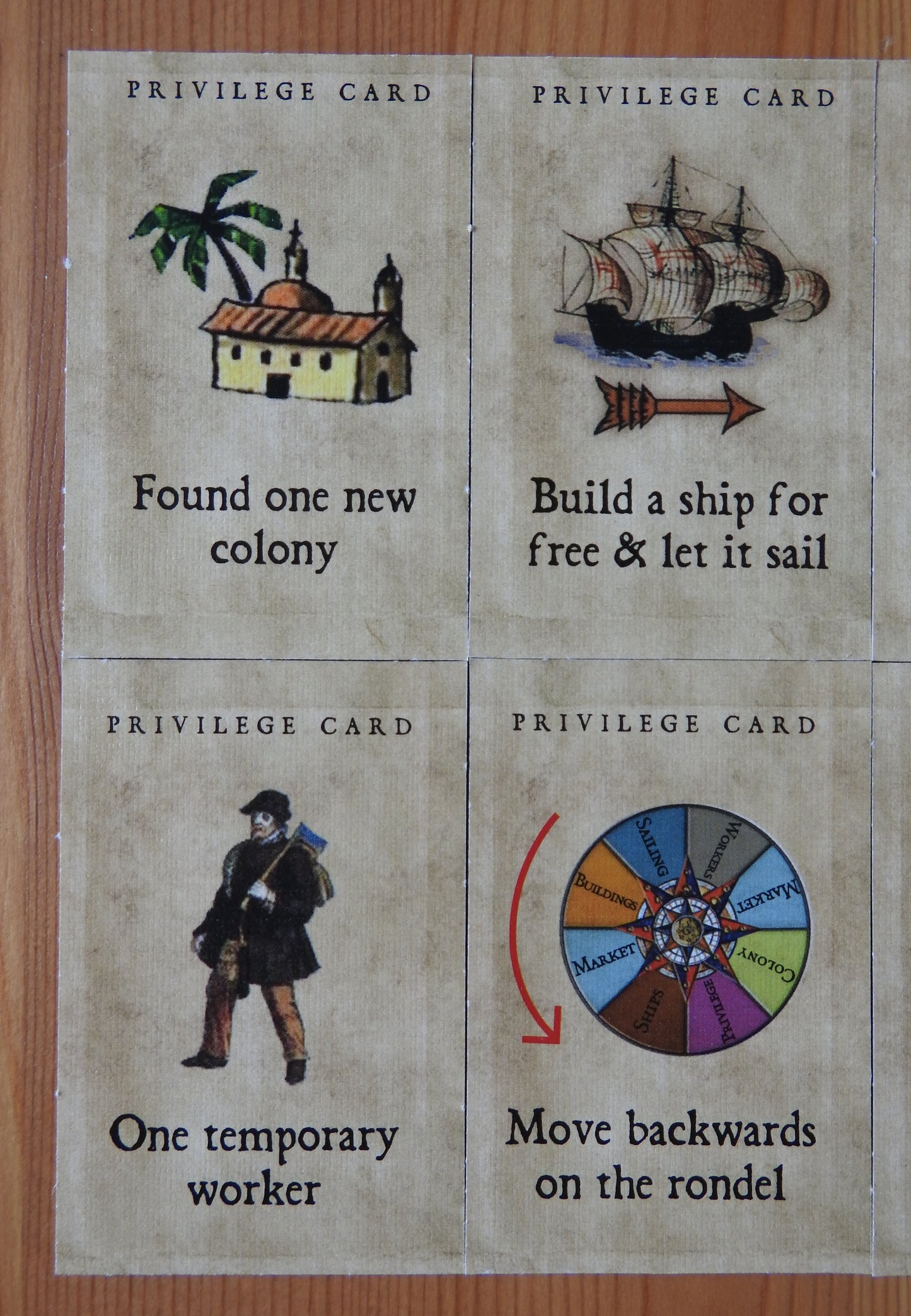 Close-up of 4 of the included tiles - they feature bonuses such as gaining a new colony and building a ship for free.