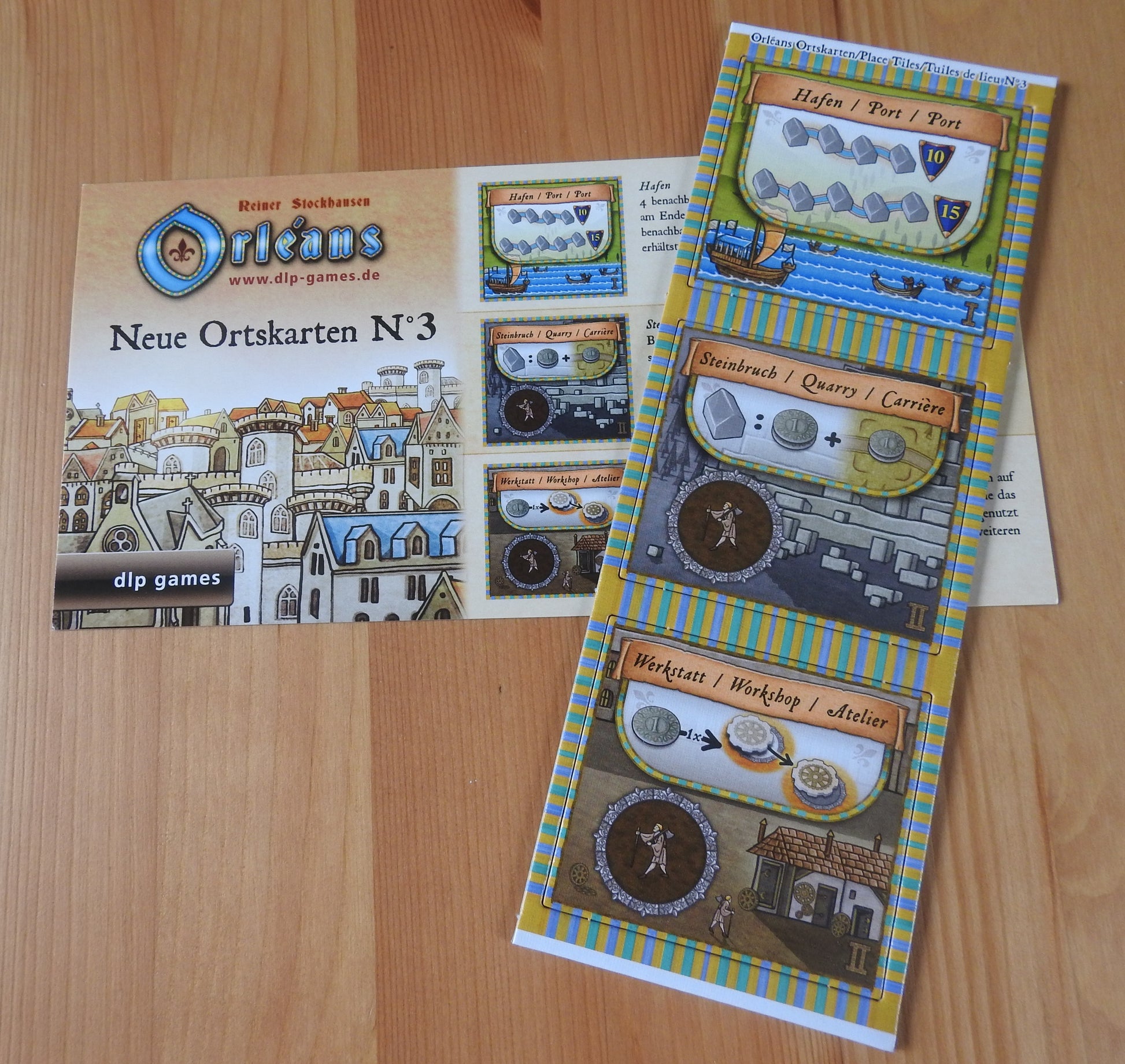 Top view of the 3 new place tiles and rules included with this Orleans - New Place Tiles No.3 mini expansion.