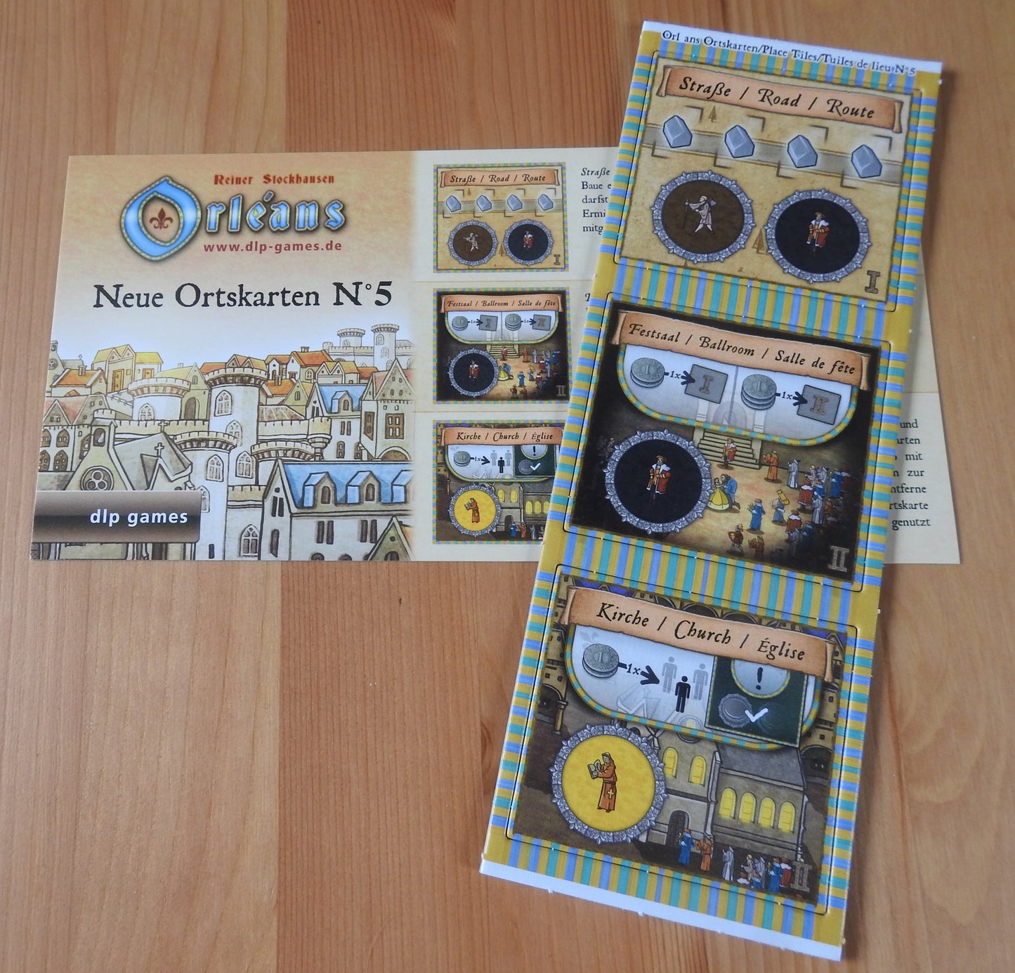Top view of the 3 new place tiles and rules included with this Orleans - New Place Tiles No.5 mini expansion.