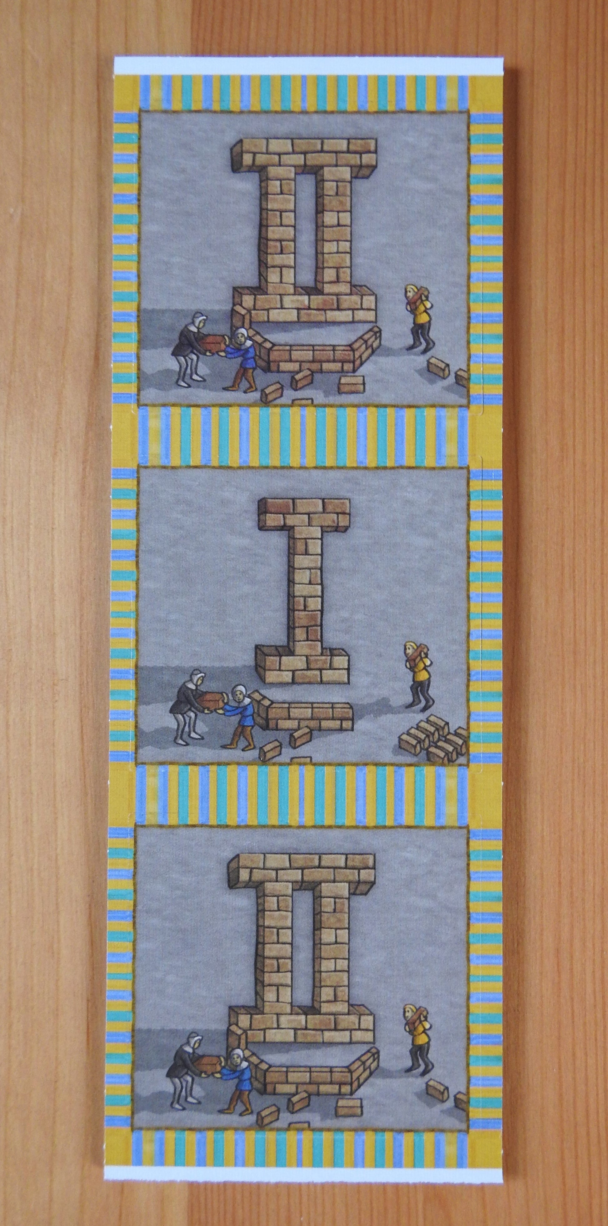 Close-up view of the back of the tiles, with 2 number II tiles and 1 number I tile.