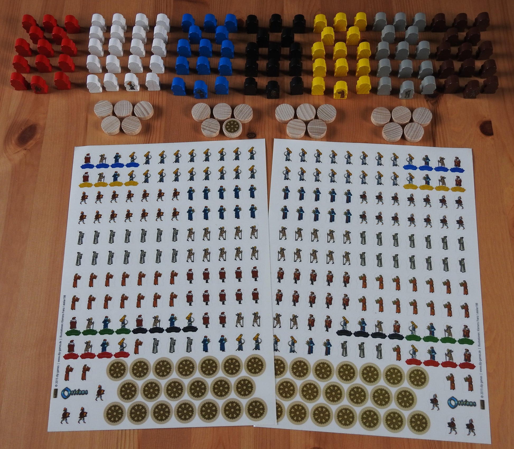 Top view of the Orleans Upgrade Kit, feauturing dozens of wooden figures and hundreds of stickers.