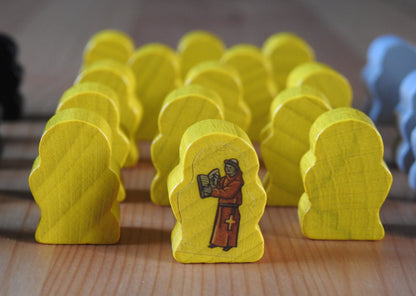 Close up view of the yellow wooden monk figures.