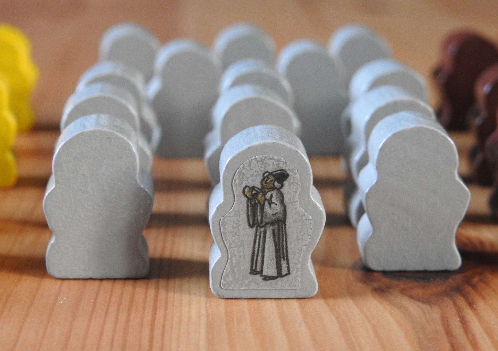 Close up view of the grey wooden scholar figures.