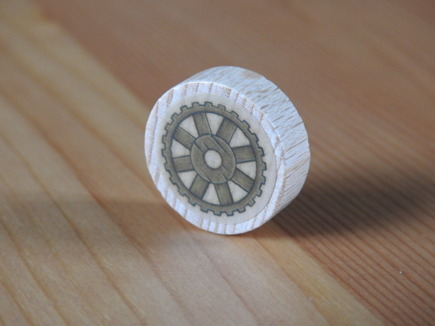 Close up of 1 of the wooden technology wheels that comes with the kit.