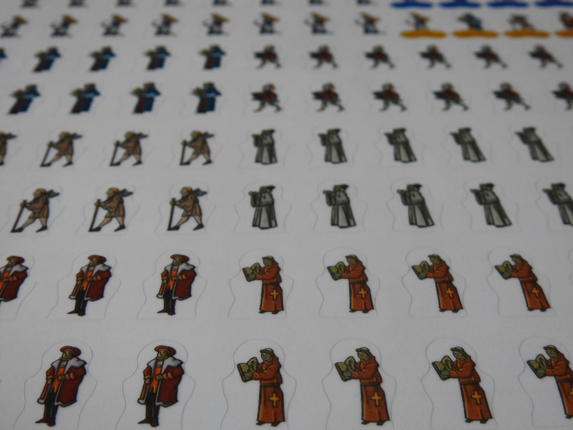 Close-up of some scholar, trader and monk stickers.