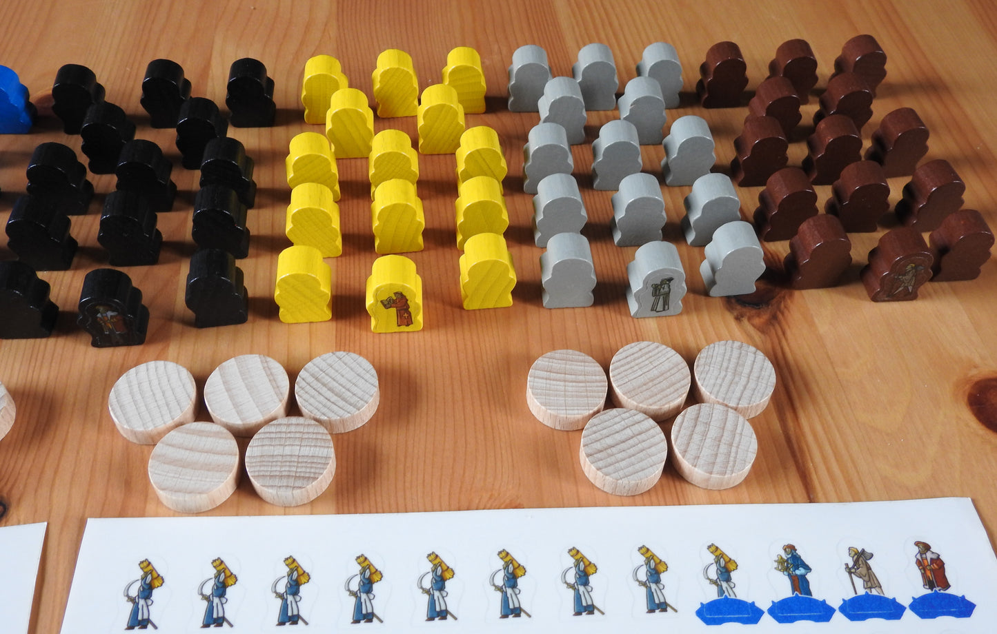 Some additional wooden figures and tokens that come in a range of colours.