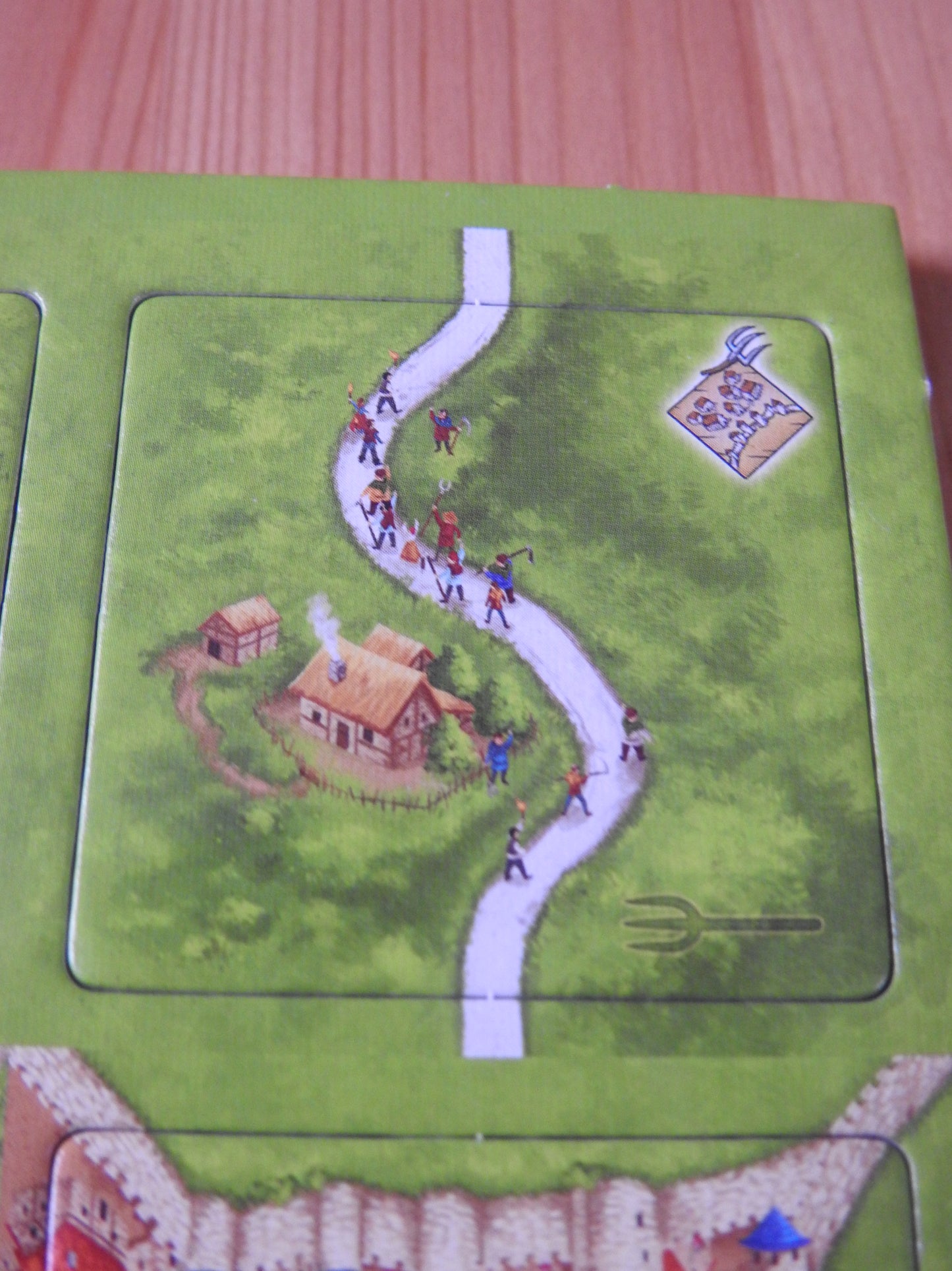 Close-up of a tile, showing peasant revolters walking down the road.