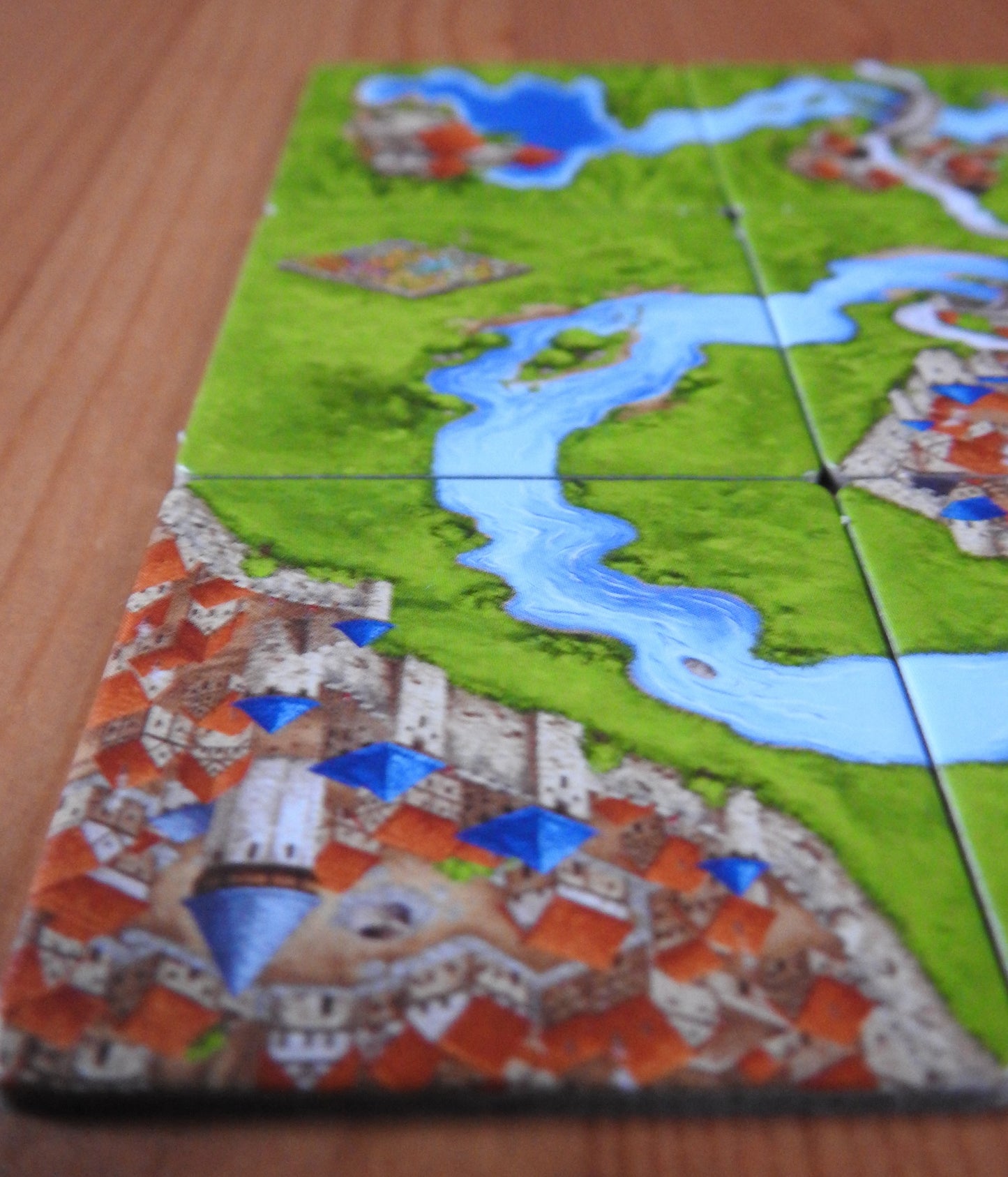 Close-up of another tile, this time part of a walled city next to a bend in the river in this River I mini expansion for Carcassonne.
