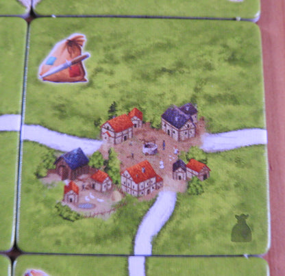 Close-up view of one of the tiles, showing roads and houses in this Carcassonne Robbers expansion.